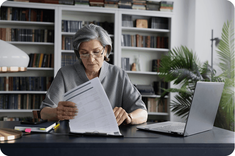 A care provider reviewing CQC registration costs at her desk